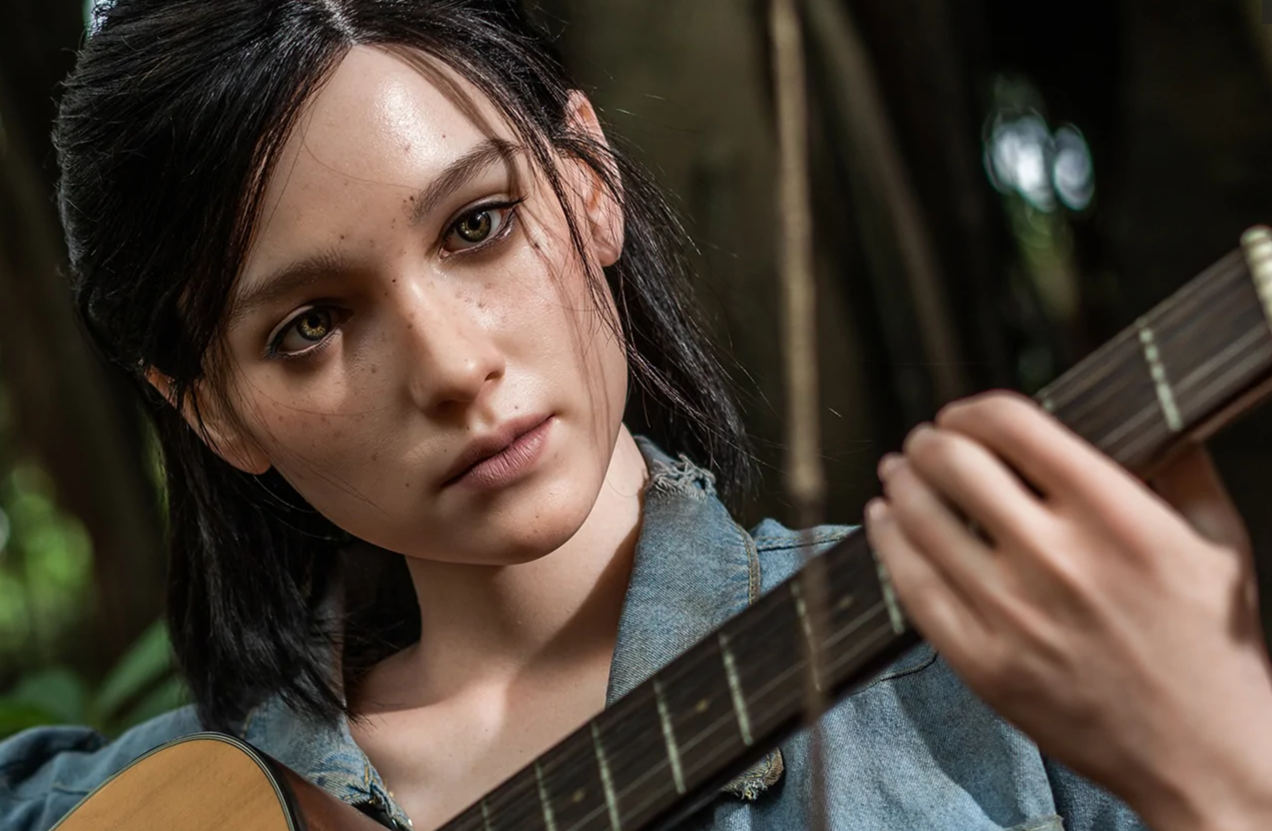 Cute love doll with freckles playing guitar